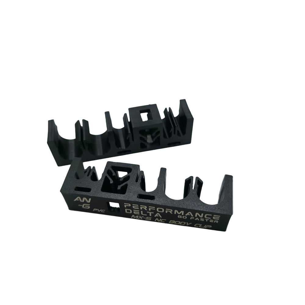 Two black nylon miata mx-5 NC car body clips on a light grey background, with one clip displaying 'AN-6 PERFORMANCE DELTA G0 FASTER MX-5 NC BODY CLIP' in white text.